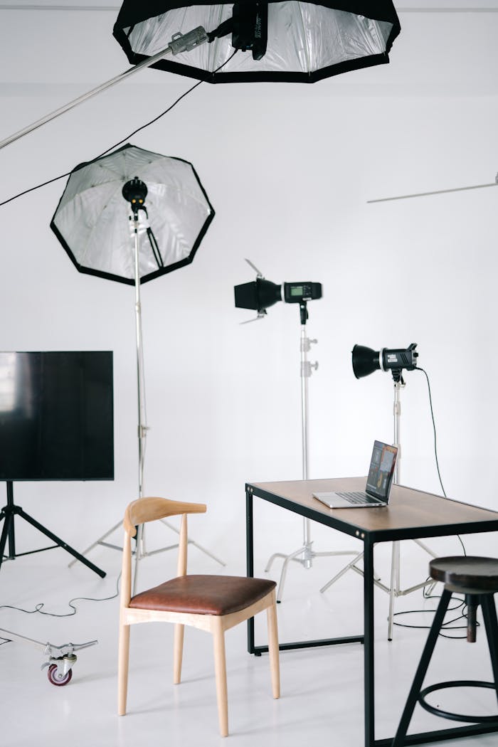 Crafting Captivating Headlines: Your awesome post title goes here Modern photography studio with lighting equipment and a laptop on a desk.
