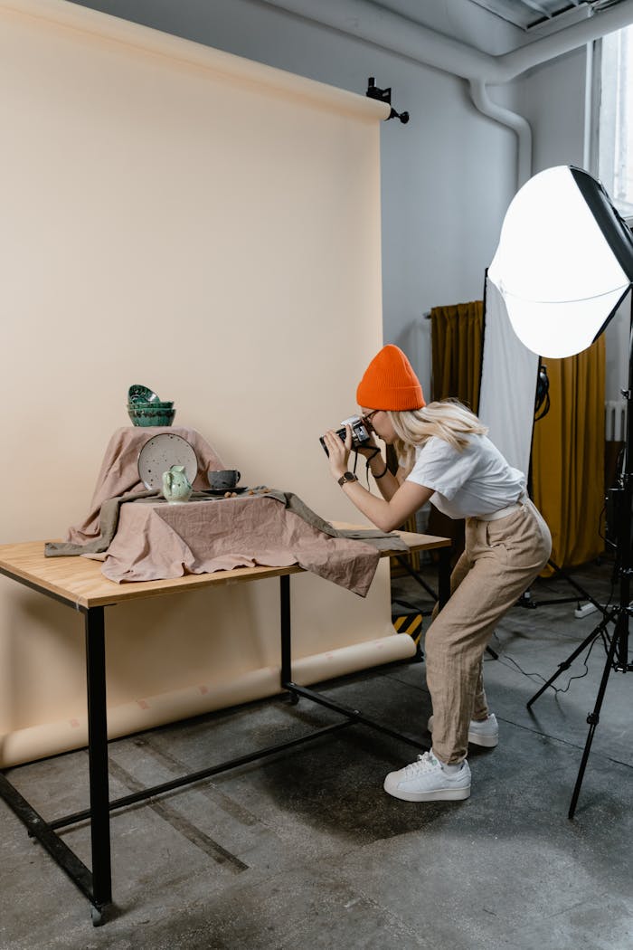 The Art of Drawing Readers In: Your attractive post title goes here Photographer shooting a still life setup in a studio with professional lighting equipment.